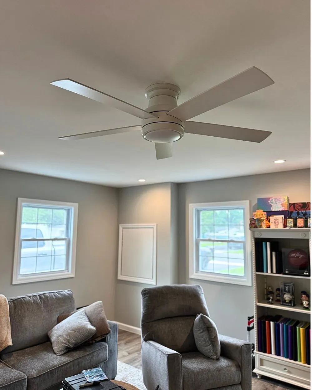 Converted garage living room with new ceiling fan and lighting